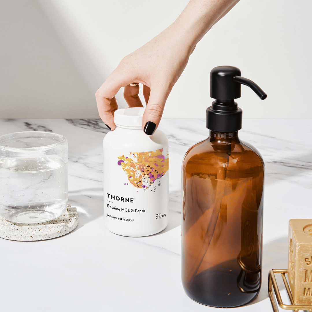 Thorne Betaine HCL & Pepsin by Thorne, betaine HCl and pepsin capsules in premium supplement bottle packaging.